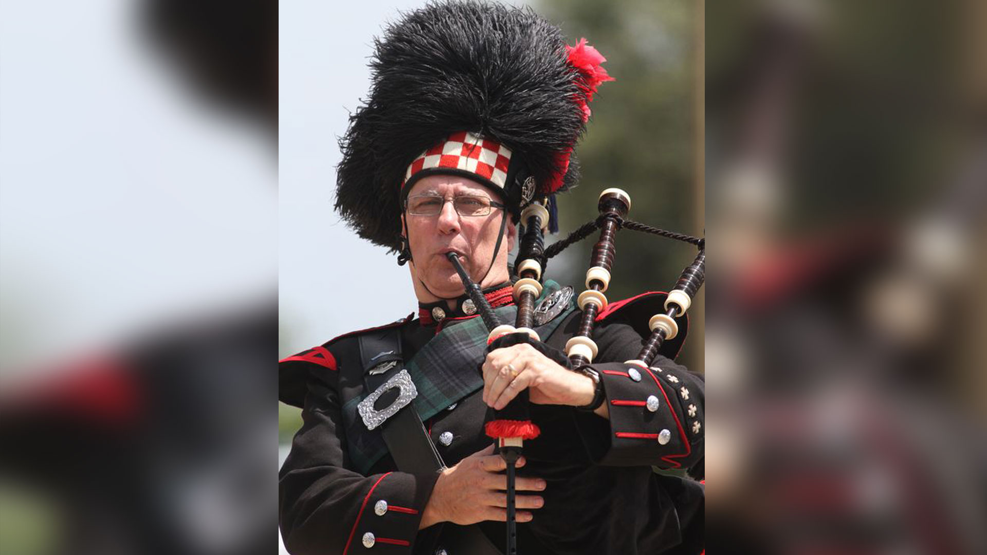 black bagpipe player image